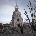 
              A Ukrainian serviceman takes a photograph of a damaged church after shelling in a residential district in Mariupol, Ukraine, Thursday, March 10, 2022. (AP Photo/Evgeniy Maloletka)
            