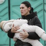 
              A woman fleeing Ukraine, holds a baby as they arrive at the border crossing in Medyka, Poland, Friday, March 4, 2022. More than 1 million people have fled Ukraine following Russia's invasion in the swiftest refugee exodus in this century, the United Nations said Thursday. (AP Photo/Visar Kryeziu)
            