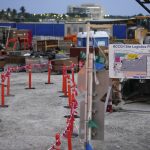 
              Supplies and equipment are seen at the entrance to the site where an 800-room luxury hotel will be built alongside the Broward County Convention Center, Tuesday, March 22, 2022, in Fort Lauderdale, Fla. An Associated Press review finds state and local governments have spent nearly $1 billion worth of federal coronavirus aid on projects that have little to do with combating the pandemic. In Broward County, $140 million will help to build an upscale hotel.  (AP Photo/Rebecca Blackwell)
            