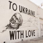 
              A mural titled "To Ukraine with Love" by street artist Corie Mattie is seen in the Arts District of downtown Los Angeles, on Monday, March 21, 2022. Artist Mattie collaborated to raise money for war victims with tattoo artist Juliano Trindade on their mural of the head of Russian President Vladimir Putin being carried away by doves. (AP Photo/Eugene Garcia)
            