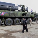 
              In this photo distributed by the North Korean government, North Korean leader Kim Jong Un, center, walks around what it says a Hwasong-17 intercontinental ballistic missile (ICBM) on the launcher, at an undisclosed location in North Korea on March 24, 2022. Independent journalists were not given access to cover the event depicted in this image distributed by the North Korean government. The content of this image is as provided and cannot be independently verified. Korean language watermark on image as provided by source reads: "KCNA" which is the abbreviation for Korean Central News Agency. (Korean Central News Agency/Korea News Service via AP)
            