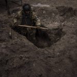 
              A Ukrainian soldier digs a foxhole in Irpin, outskirts of Kyiv, Ukraine, Sunday, March 13, 2022. (AP Photo/Felipe Dana)
            