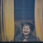 
              A child refugee fleeing the war from neighbouring Ukraine with her family grimaces as she sits in a bus after crossing the border by ferry at the Isaccea-Orlivka border crossing, in Romania, Friday, March 25, 2022. (AP Photo/Andreea Alexandru)
            