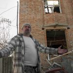 
              A man gestures next to his apartments building hit by shelling in Kharkiv, Ukraine, Sunday, March 20, 2022. (AP Photo/Andrew Marienko)
            