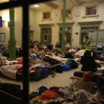 
              Women and children, fleeing from Ukraine, sleep at a makeshift shelter in the train station in Przemysl, Poland, Thursday, March 3, 2022. More than 1 million people have fled Ukraine following Russia's invasion in the swiftest refugee exodus in this century, the United Nations said Thursday. (AP Photo/Markus Schreiber)
            