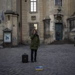 
              A man recites a poem in downtown Lviv, Western Ukraine, Saturday, March 19, 2022. Lviv has been a refuge since the war began nearly a month ago, the last outpost before Poland and host to hundreds of thousands of Ukrainians streaming through or staying on. (AP Photo/Bernat Armangue)
            