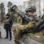 
              A Ukrainian Territorial Defence Forces member holds an NLAW anti-tank weapon, in the outskirts of Kyiv, Ukraine, Wednesday, March 9, 2022. Authorities announced a new ceasefire on Wednesday to allow civilians to escape from towns around the capital, Kyiv, as well as the southern cities of Mariupol, Enerhodar and Volnovakha, Izyum in the east and Sumy in the northeast. Previous attempts to establish safe evacuation corridors have largely failed due to attacks by Russian forces. (AP Photo/Efrem Lukatsky)
            