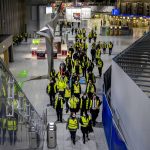 
              Security employees who control the flow of passengers and luggage walk through a terminal at the airport during a one day strike in Frankfurt, Germany, Tuesday, March 15, 2022. (AP Photo/Michael Probst)
            