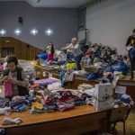 
              Ukrainian volunteers sort donated clothes for later distribution to the local population in Lviv, western Ukraine, Wednesday, March 2, 2022. Russia renewed its assault Wednesday on Ukraine’s second-largest city in a pounding that lit up the skyline with balls of fire over populated areas, even as Moscow said it would be ready to resume talks aimed at stopping the new devastating war in Europe. (AP Photo/Bernat Armangue)
            