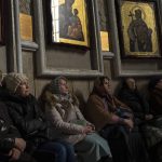 
              Women gather inside the "Transfiguration of Jesus" Orthodox Cathedral, in Kyiv, Ukraine, Sunday, March 20, 2022. (AP Photo/Rodrigo Abd)
            