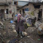 
              A woman is overwhelmed by emotion in the backyard of a house damaged by a Russian airstrike, according to locals, in Gorenka, outside the capital Kyiv, Ukraine, Wednesday, March 2, 2022. Russia renewed its assault on Ukraine's second-largest city in a pounding that lit up the skyline with balls of fire over populated areas, even as both sides said they were ready to resume talks aimed at stopping the new devastating war in Europe.(AP Photo/Vadim Ghirda)
            