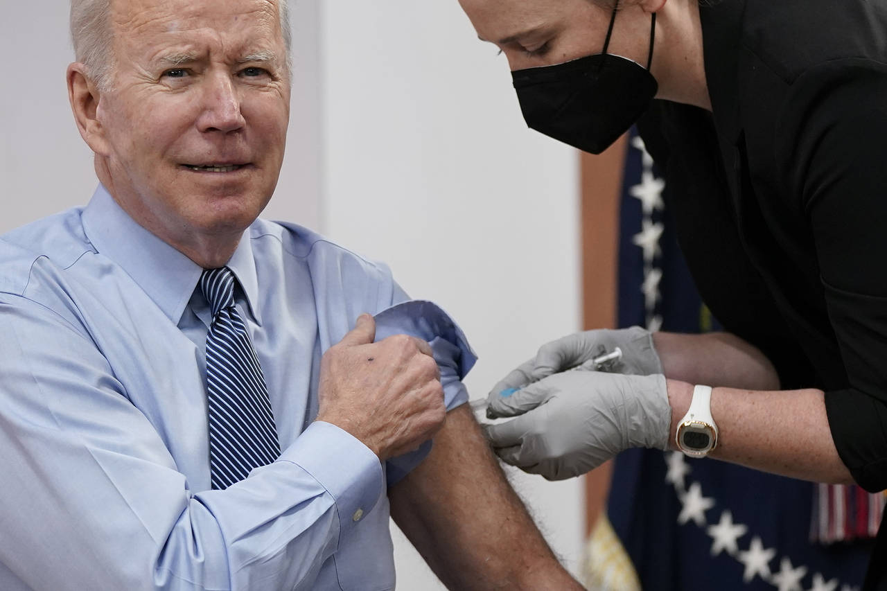 President Joe Biden receives his second COVID-19 booster shot in the South Court Auditorium on the ...