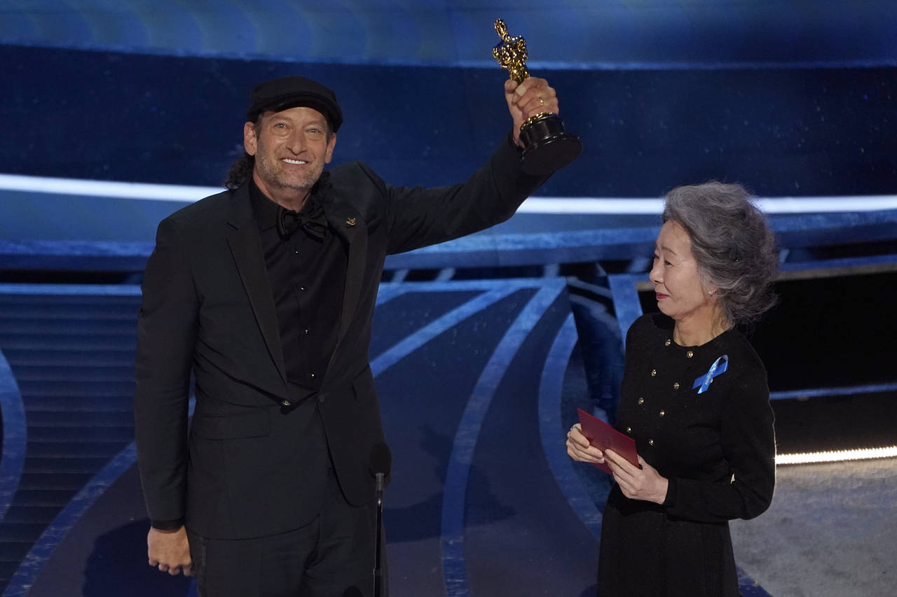 Youn Yuh-jung, right, presents Troy Kotsur with the award for best performance by an actor in a sup...
