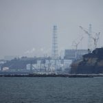 
              The Fukushima Daiichi nuclear power plant sits in coastal towns of both Okuma and Futaba, as seen from the Ukedo fishing port in Namie town, northeastern Japan, Wednesday, March 2, 2022. Eleven years after the Fukushima Daiichi nuclear power plant was ravaged by a meltdown following a massive earthquake and tsunami, the plant now looks like a sprawling construction site. Most of the radioactive debris blasted by the hydrogen explosions has been cleared and the torn buildings have been fixed. (AP Photo/Hiro Komae)
            