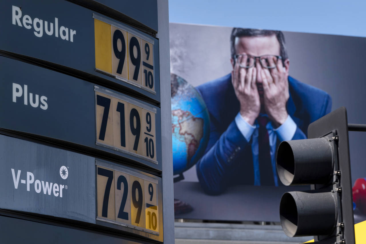 Gas prices are seen in front of a billboard advertising HBO's Last Week Tonight in Los Angeles, Mon...