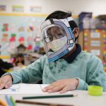 
              FILE - A student wears a mask and face shield in a 4th grade class amid the COVID-19 pandemic at Washington Elementary School on Jan. 12, 2022, in Lynwood, Calif. (AP Photo/Marcio Jose Sanchez, File)
            