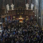 
              People attend a funeral ceremony for four of the Ukrainian military servicemen, who were killed during an airstrike in a military base in Yarokiv, in a church in Lviv, Ukraine, Tuesday, March 15, 2022. At least 35 people were killed and many wounded in Sunday's Russian missile strike on a military training base near Ukraine's western border with NATO member Poland. (AP Photo/Bernat Armangue)
            