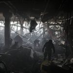 
              Ukrainian firefighters and servicemen search for people under debris inside a shopping center after bombing in Kyiv, Ukraine, Monday, March 21, 2022. (AP Photo/Felipe Dana)
            