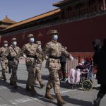 
              Chinese paramilitary policemen march past the Forbidden City on Friday, March 4, 2022, in Beijing. As China's 3,000-member ceremonial parliament prepare to open its annual session Saturday, March 5, 20222, China's defense budget, largely oriented toward possible military action in Taiwan, is another marquee item that is scrutinized closely by Congress watchers. (AP Photo/Ng Han Guan)
            