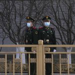 
              Chinese paramilitary policemen stand guard in the Tiananmen area near the Great Hall of the People ahead of the annual parliamentary meetings on Thursday, March 3, 2022, in Beijing. China's 3,000-member ceremonial parliament will open its annual session Saturday with the government facing a slowing economy and international pressure over its stance on Russia's invasion of Ukraine. (AP Photo/Ng Han Guan)
            