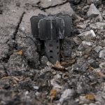 
              A part of a mortar shell sticks out of the asphalt in Stoyanka, Ukraine, Sunday, March 27, 2022. Ukrainian President Volodymyr Zelenskyy accused the West of lacking courage as his country fights to stave off Russia's invading troops, making an exasperated plea for fighter jets and tanks to sustain a defense in a conflict that has ground into a war of attrition. (AP Photo/Vadim Ghirda)
            