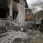 
              A Ukrainian serviceman walks by a heavily damaged building in Stoyanka, Ukraine, Sunday, March 27, 2022. Ukrainian President Volodymyr Zelenskyy accused the West of lacking courage as his country fights to stave off Russia's invading troops, making an exasperated plea for fighter jets and tanks to sustain a defense in a conflict that has ground into a war of attrition. (AP Photo/Vadim Ghirda)
            