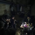 
              Residents prepare tea as they sit in a basement being used as a bomb shelter in Irpin, outskirts of Kyiv, Ukraine, Sunday, March 13, 2022. (AP Photo/Felipe Dana)
            