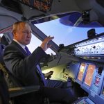 
              Russian President Vladimir Putin sits in the cockpit of an airplane simulator as he visits Aeroflot Aviation School outside Moscow, Russia, Saturday, March 5, 2022. (Sputnik, Kremlin Pool Photo via AP)
            