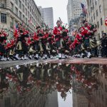 Bagpipers march up Fifth Avenue while they pass in front of St. Patrick Cathedral during the St. Patrick's Day Parade, Thursday, March 17, 2022, in New York.  St. Patrick's Day celebrations across the country are back after a two-year hiatus. That includes New York City's parade, the nation's largest and oldest. It's a sign of growing hope that the worst of the coronavirus pandemic may be over. (AP Photo/Eduardo Munoz Alvarez)