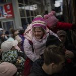 
              People holding their children struggle to get on a train to Lviv at the Kyiv station, Ukraine, Monday, March 7, 2022. Russia announced yet another cease-fire and a handful of humanitarian corridors to allow civilians to flee Ukraine. Previous such measures have fallen apart and Moscow's armed forces continued to pummel some Ukrainian cities with rockets Monday. (AP Photo/Emilio Morenatti)
            