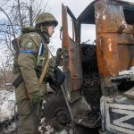 
              A Ukrainian National guard soldier inspects a Russian damaged military vehicle in Kharkiv, Ukraine, Wednesday, March 16, 2022. NATO Secretary-General Jens Stoltenberg made it clear Tuesday that the 30-nation military alliance is set to radically change its security stance in Europe in response to Russia's war on Ukraine. (AP Photo/Andrew Marienko)
            