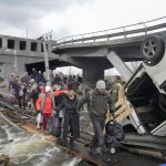 
              People cross an improvised path under a destroyed bridge while fleeing the town of Irpin close to Kyiv, Ukraine, Monday, March 7, 2022.Russia announced yet another cease-fire and a handful of humanitarian corridors to allow civilians to flee Ukraine. Previous such measures have fallen apart and Moscow’s armed forces continued to pummel some Ukrainian cities with rockets Monday. (AP Photo/Efrem Lukatsky)
            