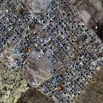 This multispectral satellite image provided by Maxar Technologies shows destroyed homes, impact craters and fires in town of Moschun, Ukraine, during the Russian invasion, Friday, March 11, 2022. (Satellite image ©2022 Maxar Technologies via AP)