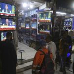 
              People watches news channels broadcast a live address to the nation by Pakistan's Prime Minister Imran Khan at a market, in Karachi, Pakistan, Thursday, March 31, 2022. Pakistan's embattled Prime Minister Khan remained defiant on Thursday, telling the nation that he will not resign even as he faces a no-confidence vote in parliament and the country's opposition says it has the numbers to push him out. (AP Photo/Fareed Khan)
            