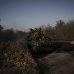 
              Ukrainian servicemen ride atop a tank near the town of Trostsyanets, Ukraine, Monday, March 28, 2022. Trostsyanets was recently retaken by Ukrainian forces after being held by Russians since the early days of the war. (AP Photo/Felipe Dana)
            