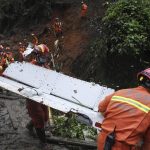 
              In this photo released by Xinhua News Agency, search and rescue workers carry pieces of debris which were recovered at the China Eastern flight crash site in Tengxian County in southern China's Guangxi Zhuang Autonomous Region on Thursday, March 24, 2022. Hundreds of people in rain gear and rubber boots searched muddy, forested hills in southern China on Thursday for the second flight recorder from a jetliner that crashed with 132 people aboard. (Lu Boan/Xinhua via AP)
            