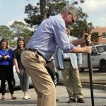 
              Rep. Tom Rice, R-S.C.,  helps fill in a pothole at a Department of Transportation facility in Florence, S.C., on Feb. 24, 2022. Rice is one of two South Carolina House Republicans facing spirited primary challenges this summer from rivals backed by former President Donald Trump that could signal the former president's grip on the party as he weighs another White House bid. (AP Photo/Meg Kinnard)
            