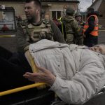 
              An elderly woman lies on a stretcher in Irpin, on the outskirts of Kyiv, Ukraine, Tuesday, March 8, 2022. Demands for ways to safety evacuate civilians have surged along with intensifying shelling by Russian forces, who have made significant advances in southern Ukraine but stalled in some other regions. Efforts to put in place cease-fires along humanitarian corridors have repeatedly failed amid Russian shelling. (AP Photo/Vadim Ghirda)
            