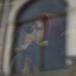 
              A child who fled the war in Ukraine waits in a bus after arriving to Przemysl train station in Przemysl, Poland, Tuesday, March 15, 2022. (AP Photo/Petros Giannakouris)
            