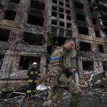 
              Ukrainian soldiers and firefighters search in a destroyed building after a bombing attack in Kyiv, Ukraine, Monday, March 14, 2022. (AP Photo/Vadim Ghirda)
            
