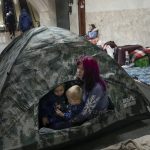 
              A woman and her children sit in a tent in the Kyiv subway, using it as a bomb shelter in Kyiv, Ukraine, Wednesday, March 2, 2022. Russian forces have escalated their attacks on crowded cities in what Ukraine's leader called a blatant campaign of terror. (AP Photo/Efrem Lukatsky)
            