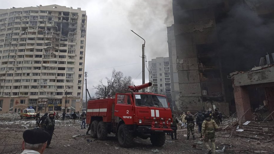 Firefighters work to extinguish a fire at a damaged city center after Russian air raid in Chernigiv...