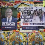 
              Electoral posters of French far-right presidential candidate Eric Zemmour with the writing "facho" (fascist) on his face are displayed in Genay, outside Lyon, central France, Saturday, April 9, 2022. France's first round of the presidential election will take place on April 10, with a presidential runoff on April 24 if no candidate wins outright. (AP Photo/Laurent Cipriani)
            
