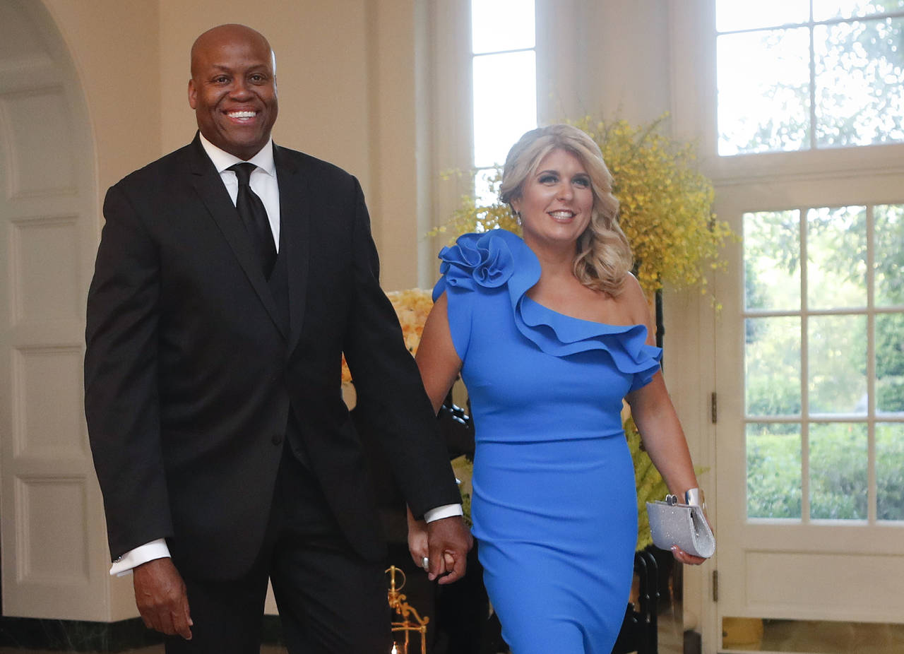 FILE - Craig Robinson, brother of former first lady Michelle Obama, and his wife, Kelly Robinson, a...