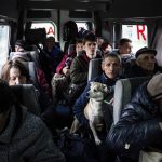 
              People sit in a bus during evacuation from Lyman, Donetsk region, eastern Ukraine, Saturday, April 30, 2022. (AP Photo/Evgeniy Maloletka)
            