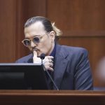 
              Actor Johnny Depp listens as he testifies in the courtroom at the Fairfax County Circuit Court in Fairfax, Va., Thursday, April 21, 2022. Actor Johnny Depp sued his ex-wife Amber Heard for libel in Fairfax County Circuit Court after she wrote an op-ed piece in The Washington Post in 2018 referring to herself as a "public figure representing domestic abuse." (Jim Lo Scalzo/Pool Photo via AP)
            