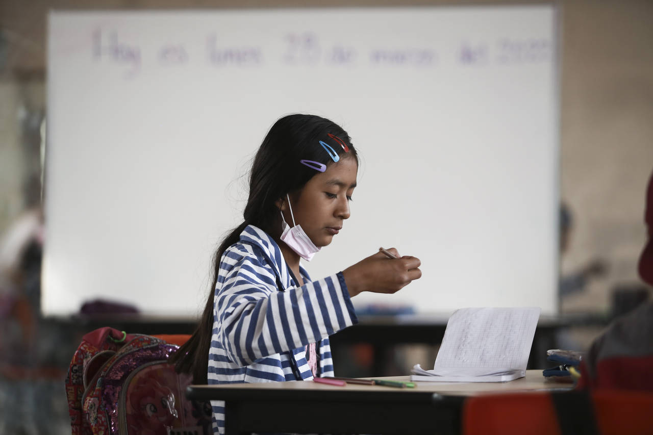 A student focuses on her lesson at Casa Kolping, an alternative education center where child migran...