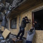 
              Local residents close the windows of an apartment building with plywood after Russian shelling in Dobropillya, Donetsk region, eastern Ukraine, Saturday, April 30, 2022. (AP Photo/Evgeniy Maloletka)
            