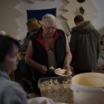 
              Vladimir, 64, who left his home in Severodonetsk due to the Russian attacks, serves his lunch prepared by volunteers in a restaurant that was transformed into a shelter for those who are fleeing the war from the eastern region of the country in Dnipro, Ukraine, Wednesday, April 20, 2022. The U.N. refugee agency says more than 5 million refugees have fled Ukraine since Russian troops invaded the country. The agency announced the milestone in Europe's biggest refugee crisis since World War II on Wednesday, April 20, 2022. (AP Photo/Leo Correa)
            