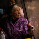 
              Kateryna Hodza, 85, takes a bus from a reception center for displaced people in Zaporizhzhia, Ukraine, Friday, April 29, 2022. They fled from Mala Tokmachka, in Zaporizhzhia region, as thousands of Ukrainian continue to leave Russian occupied areas. (AP Photo/Francisco Seco)
            